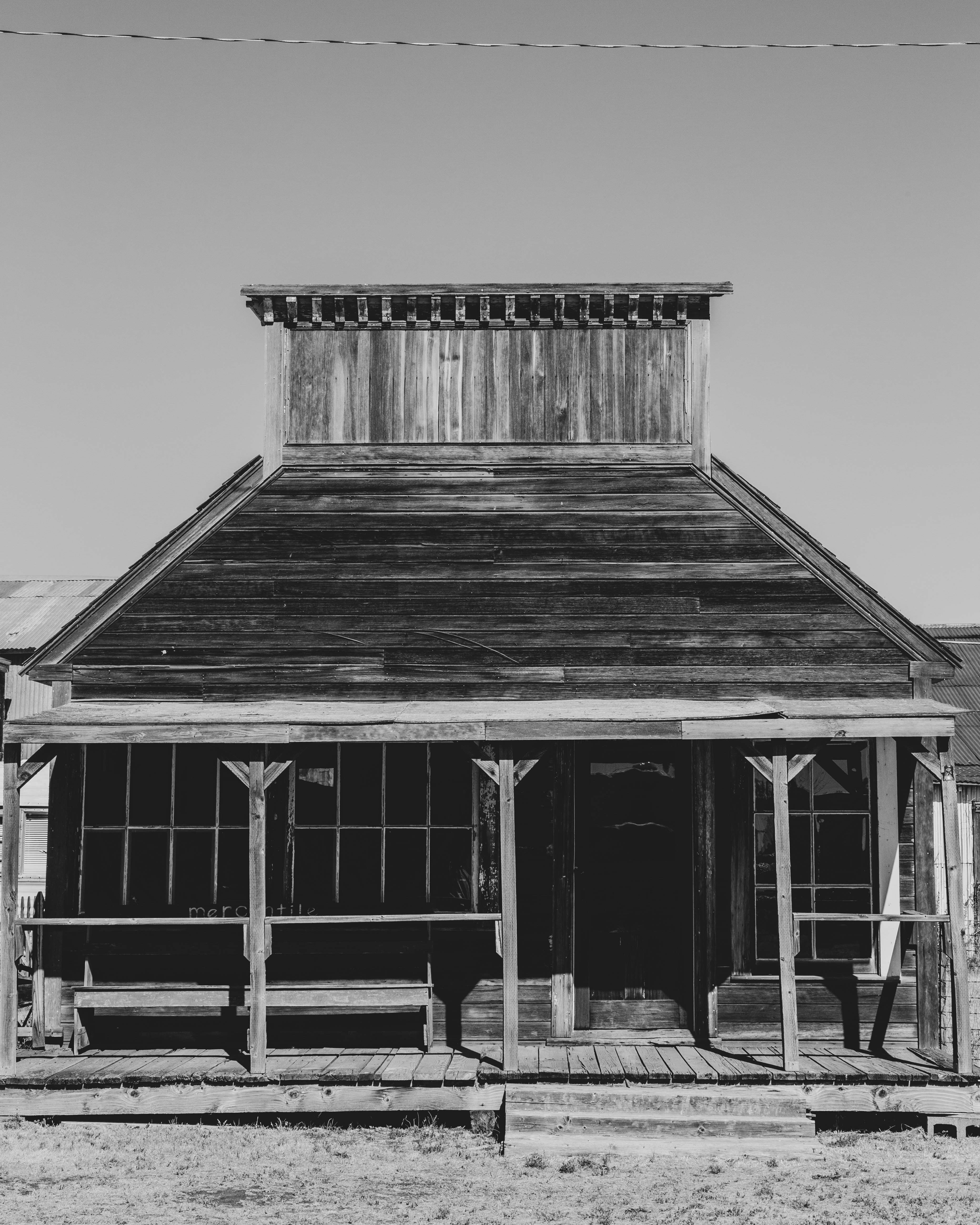 grayscale photo of wooden house